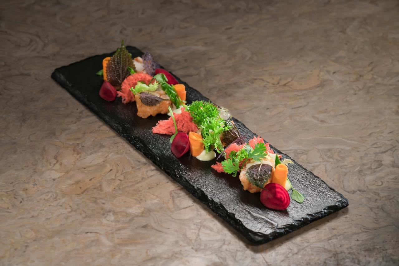 Vinpearl Resort & Spa Phu Quoc Extérieur photo A salad on a slate plate